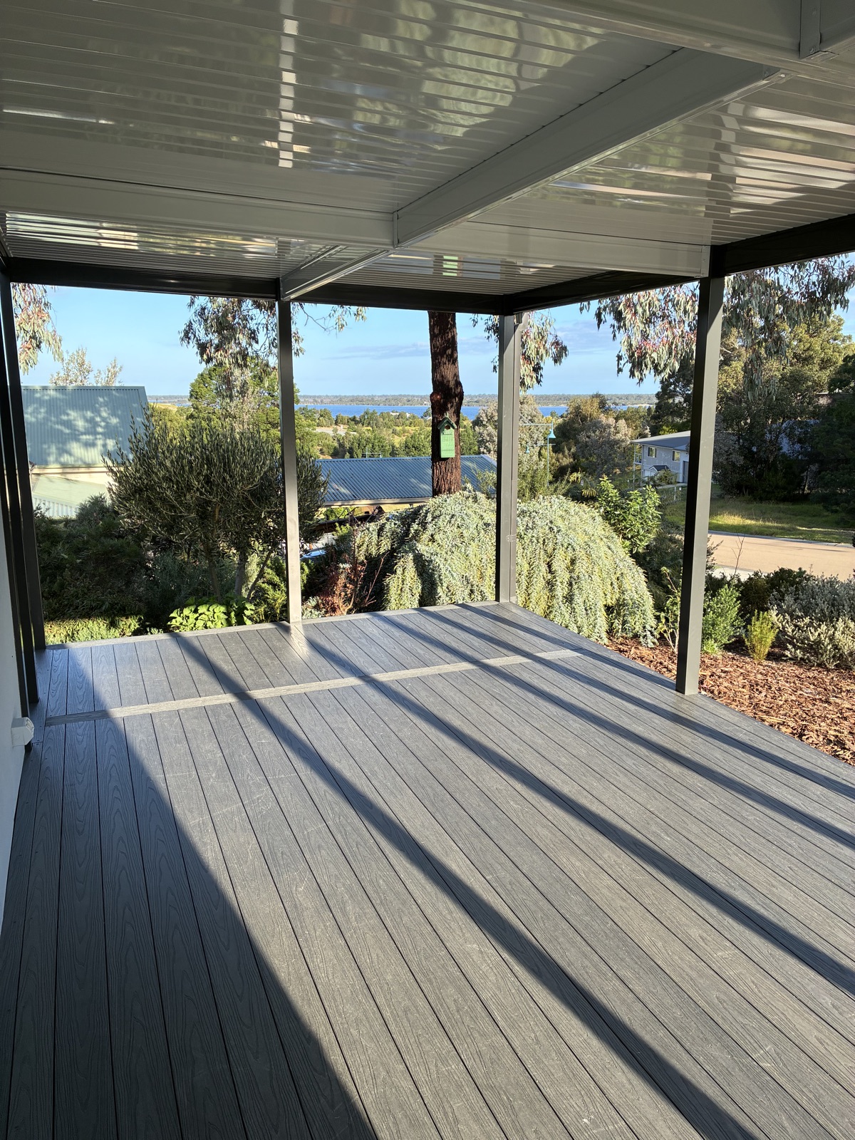 Composite deck with a garden and water outlook by NPD Building Solutions